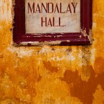 Old Mandalay Hall sign on colourful wall, outside an abandoned Jewish house.